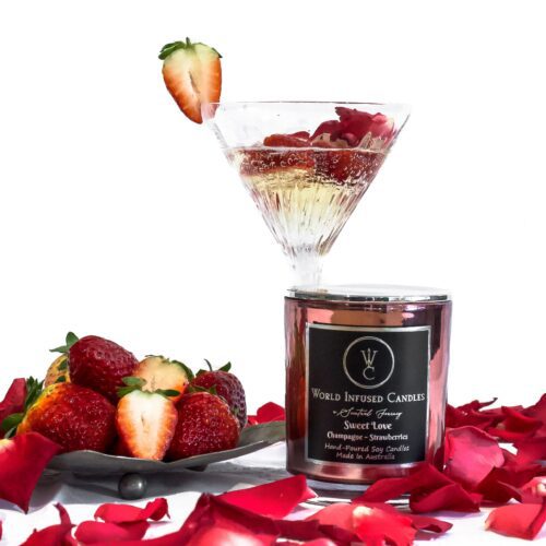 Front shot of Sweet love with a white background. Champagne and strawberries are scene in the background with red rose petals in the front